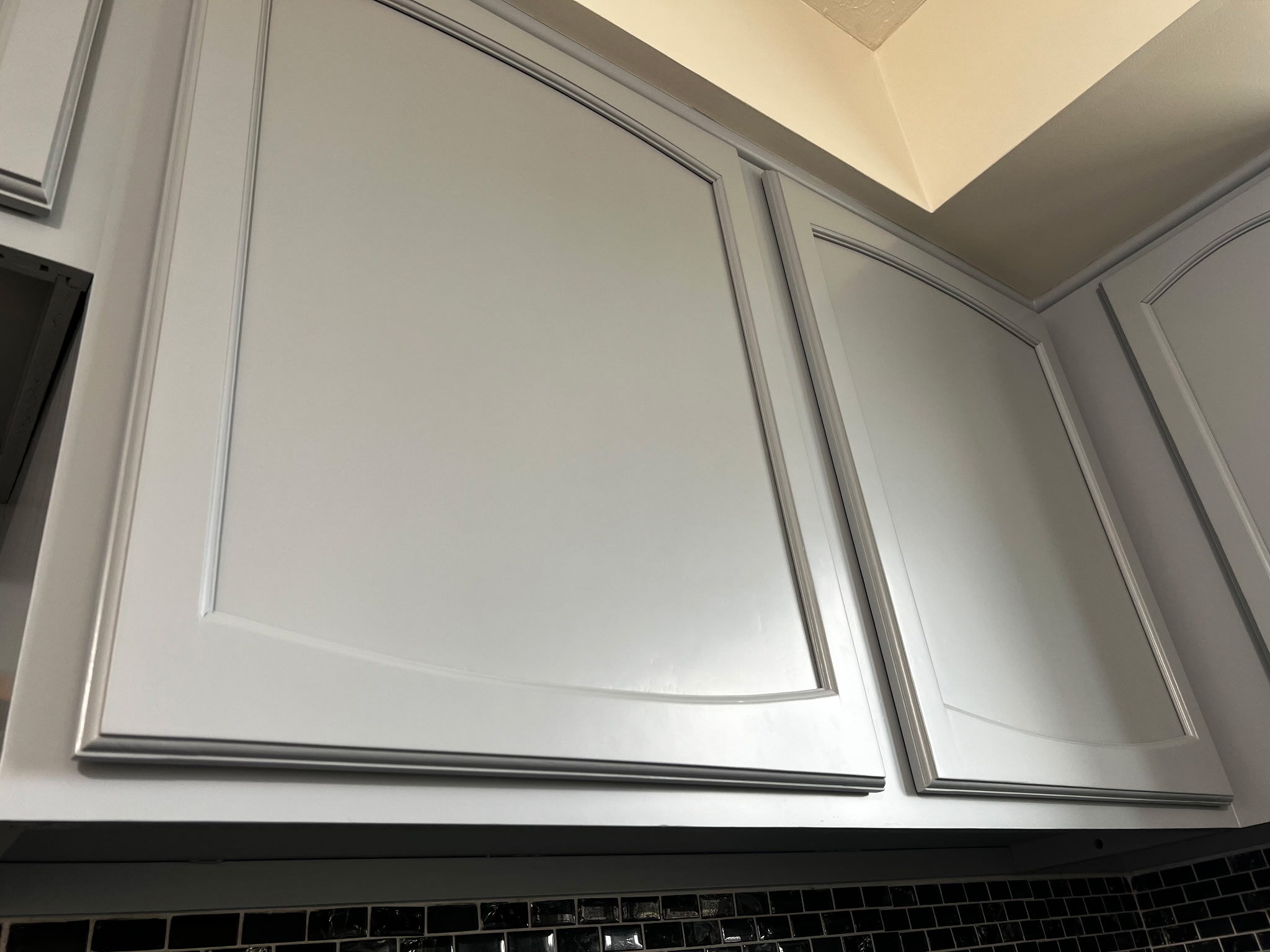 Close up of cabinet door after being painted by Brush & Roll Painting in Omaha, NE.