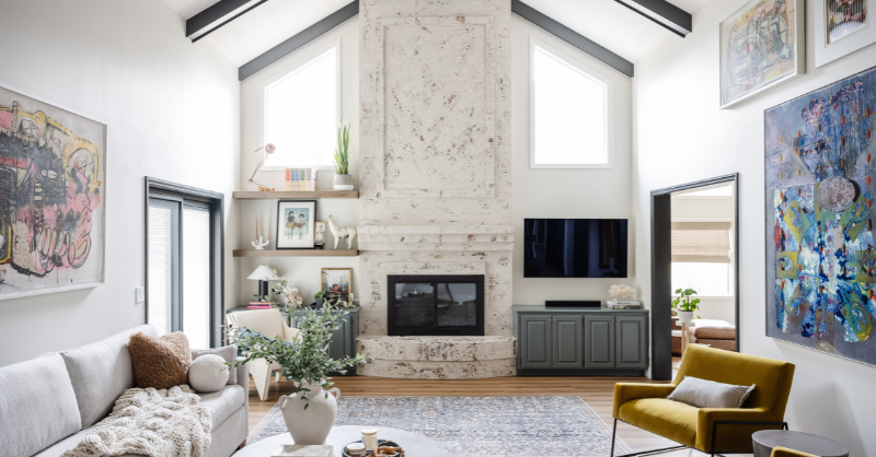 Living room with large brick fireplace and white walls.