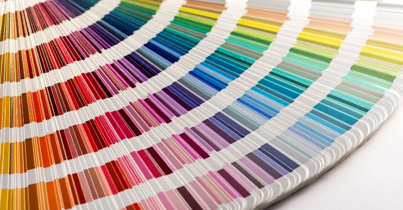 Color swatches layed out on a desk of all paint colors.