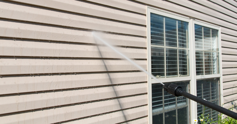 Warm light brown, beige exterior of house being power washed in Omaha.