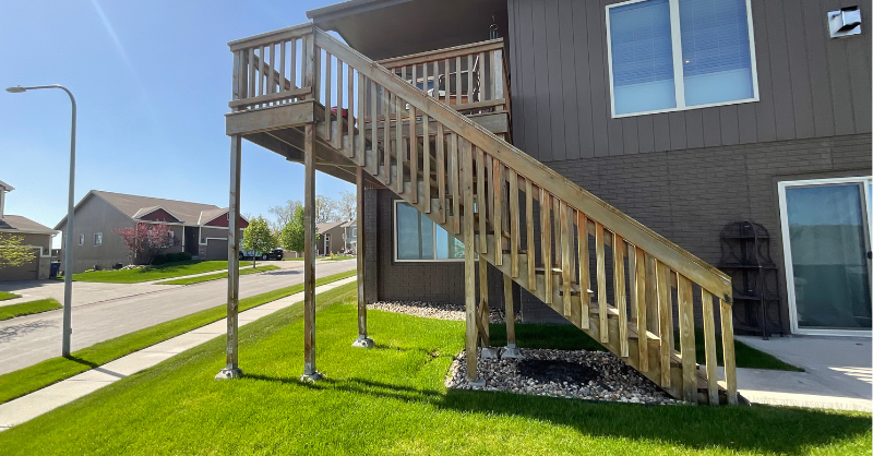 Wooden deck that has not been stained with stairs, in Omaha, NE.