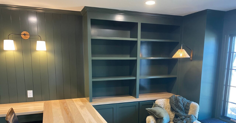 Desk and shelving custom build painted dark green with light hardwood.