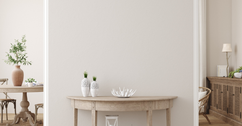 Interior wall in a hallway and dining room with a light neutral warm paint color on the walls.