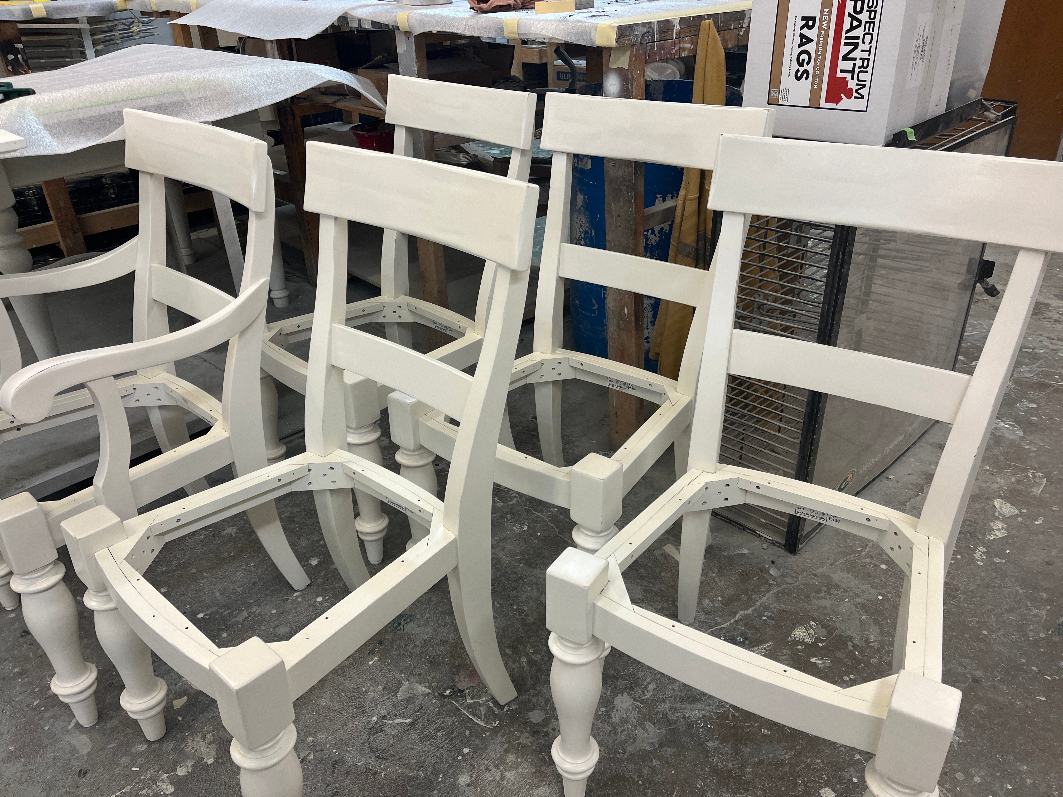 Wood chairs in the process of being painted at Brush & Roll Painting in Omaha, NE.