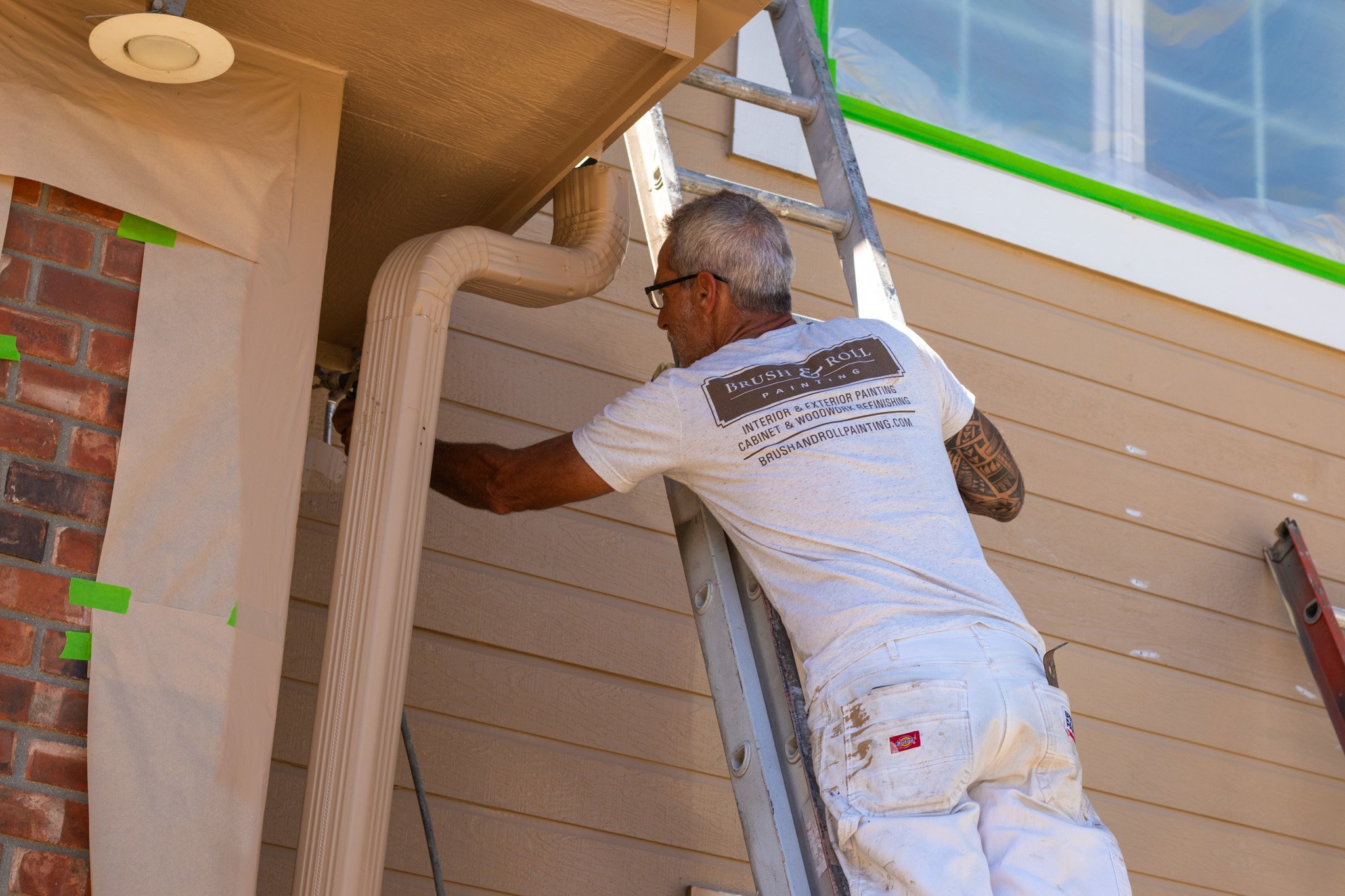 Brush & Roll Painting painter painting the exterior of a home near Omaha, NE.