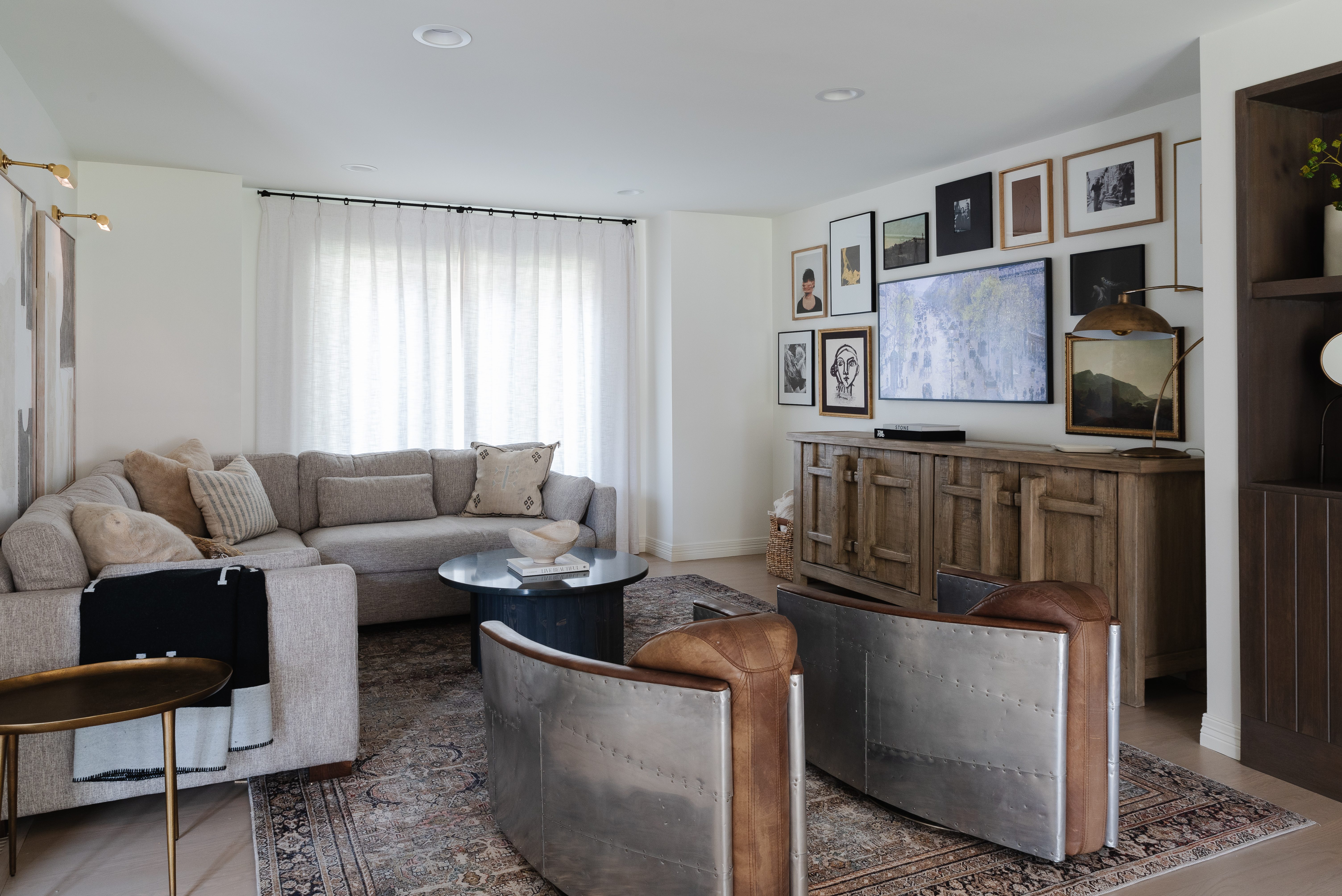 Living room with decor hung on main wall painted white.