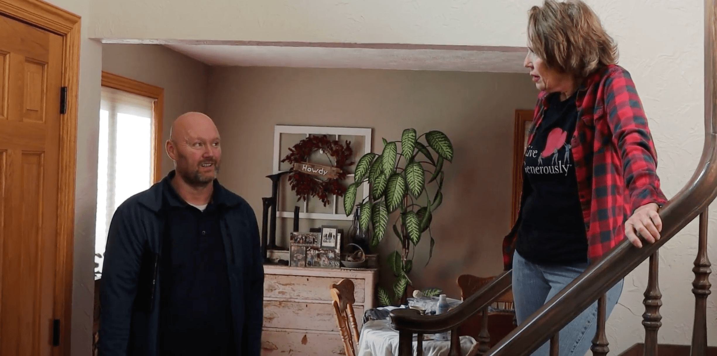 Bill Carlson, owner of Brush & Roll Painting talking with a homeowner in her home about her painting project.