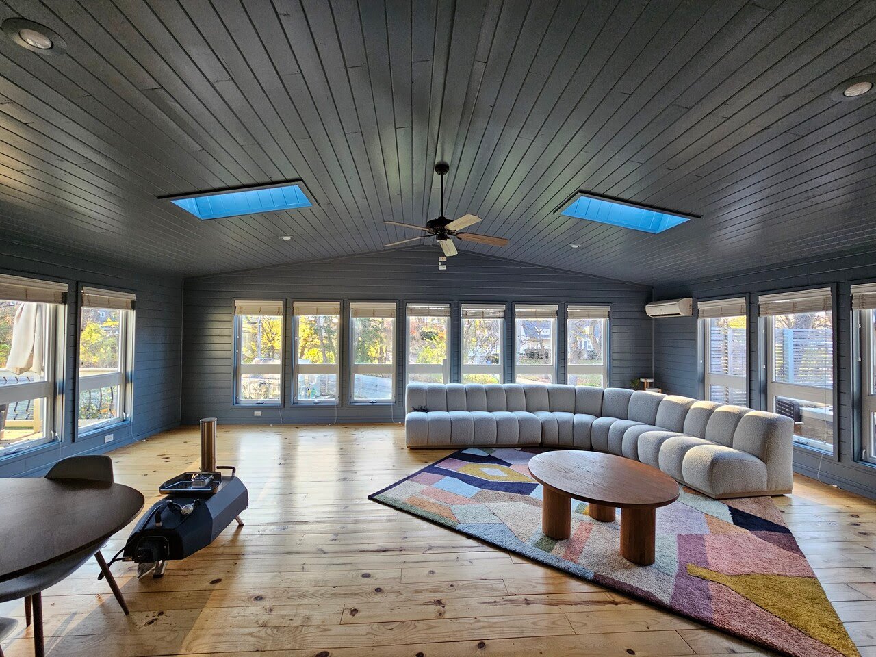 Sun room painted with a dark grey/off-blue shade on walls and ceilings.