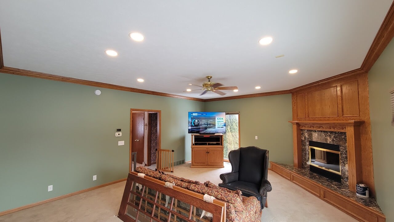 Interior living room with oak wood trim and sage green painted walls.