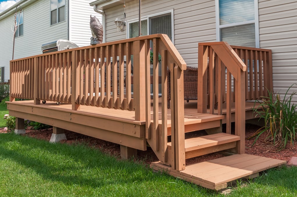 Deck on the back of a home stained with a warm orange brown shade in Omaha, NE.